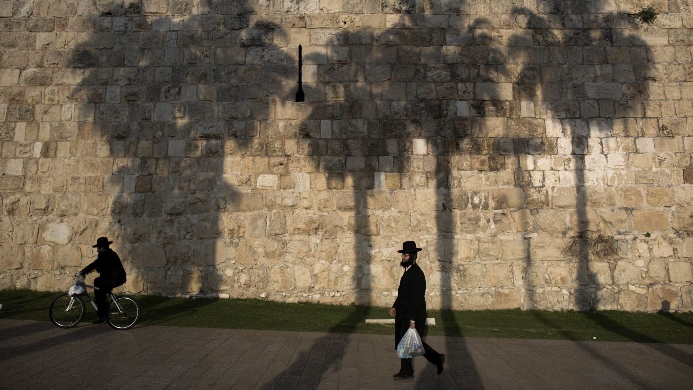 An ultra-Orthodox Jewish man walks near the wall of the Old City of<br />Jerusalem on Monday, December 29.