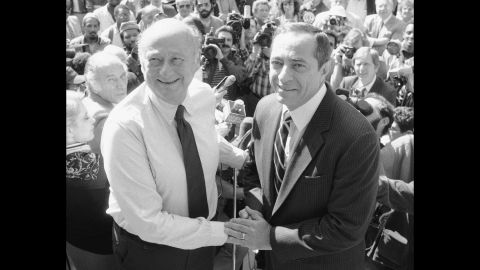 New York Mayor Ed Koch shakes hands with Cuomo on the steps of City Hall in New York on October 7, 1985. Cuomo announced his endorsement of Koch for mayor. 