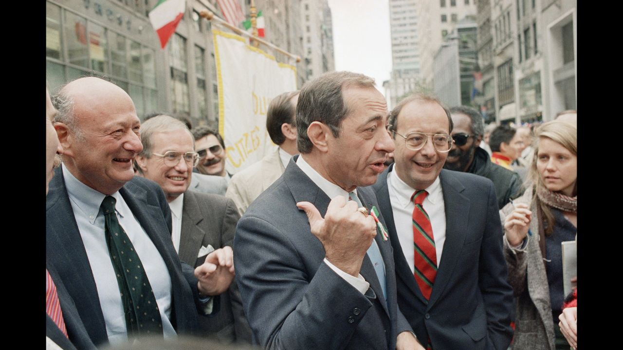 New York's Mayor Ed Koch, left; behind him, New York's Lt. Gov. Stanley Lundine; Cuomo, center; and Sen. Alfonse D'Amato, right, share a laugh at the Columbus Day Parade along New York's Fifth Avenue on October 12, 1987.