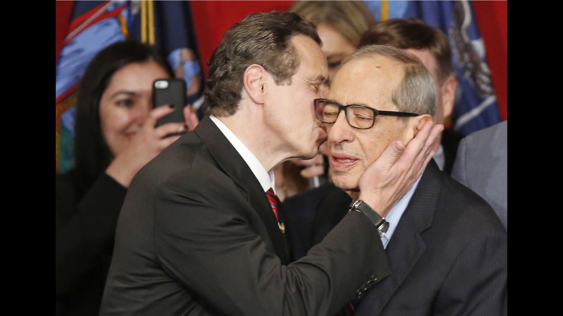 Gov. Andrew Cuomo kisses his father, celebrating his defeat of Republican challenger Rob Astorino, at Democratic election headquarters in New York on November 4, 2014. 