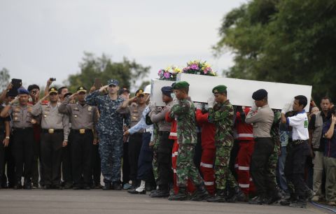 Members of the National Search and Rescue Agency and Indonesian soldiers carry coffins containing bodies of victims in Pangkalan Bun on January 2.