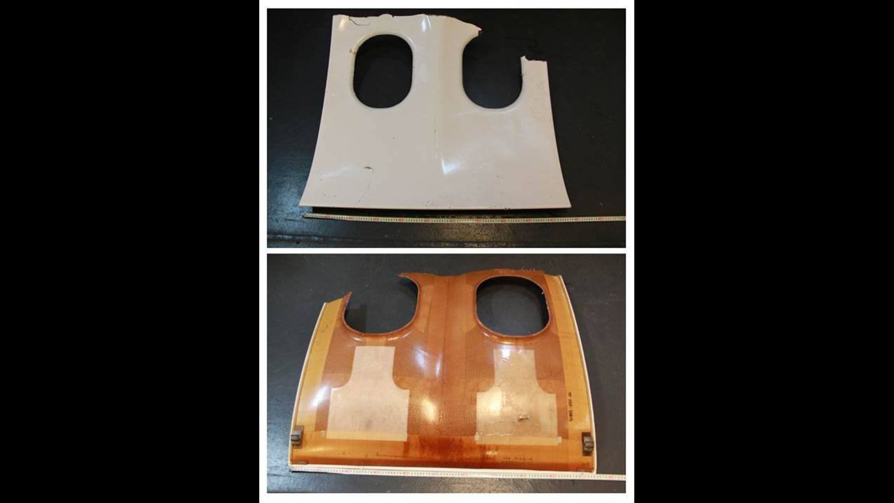 This photograph released by the Singapore Defense Ministry shows the front and back of a piece of debris that resembles an aircraft window panel.