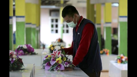A member of the Indonesian Red Cross prepares coffins at a hospital in Pangkalan Bun on January 2. 