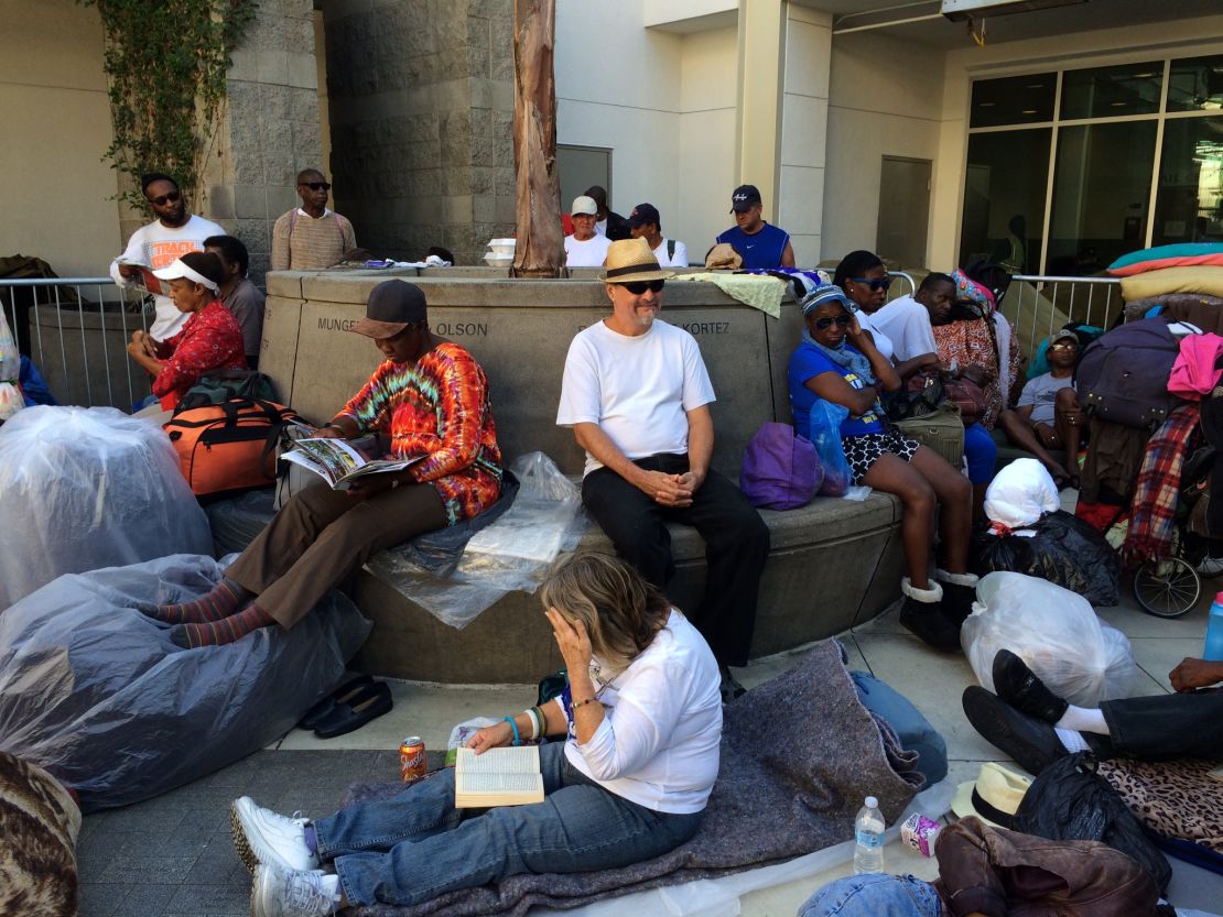 Long before the sun sets, people start lining up outside Skid Row's missions. 
