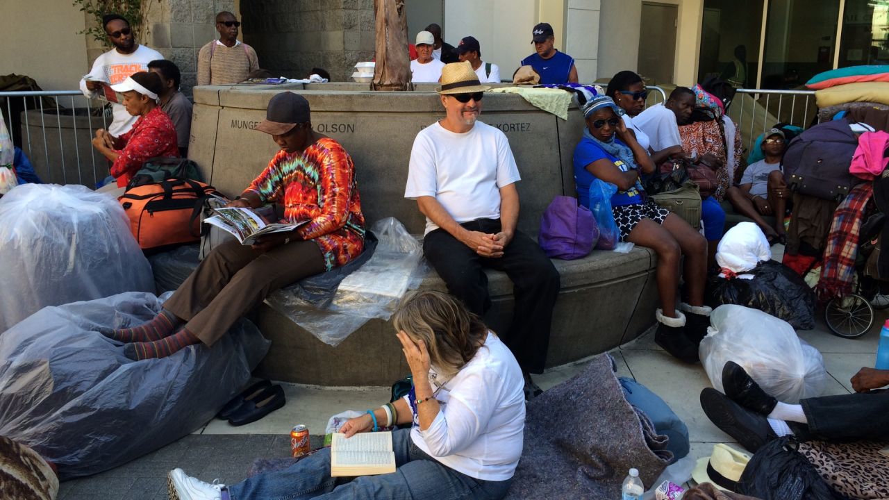 Long before the sun sets, people start lining up outside Skid Row's missions. 
