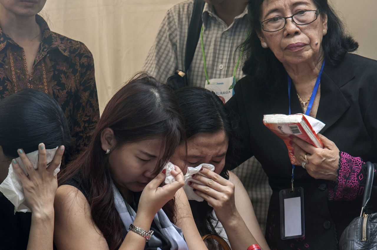 Relatives and friends grieve as they attend a ceremony January 2 in Surabaya.