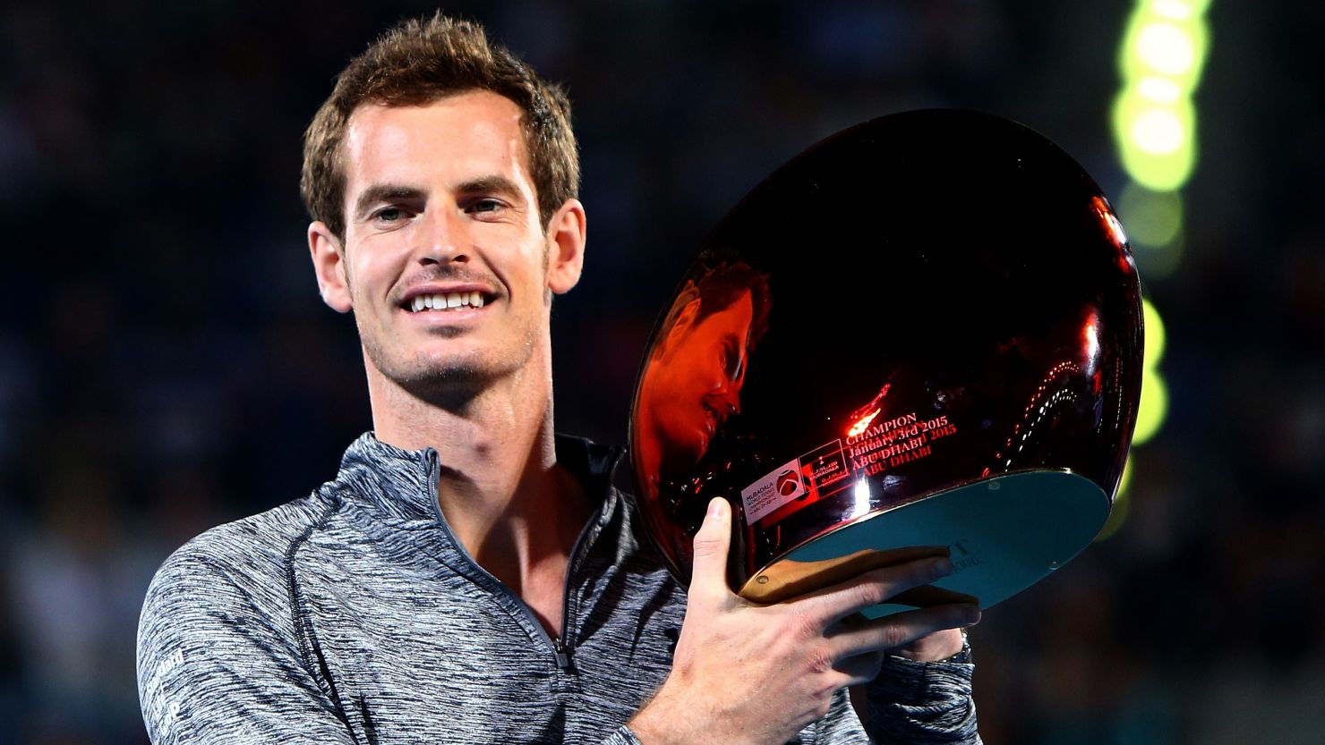 Andy Murray poses with the Mubadala WTC trophy following the withdrawal of Novak Djokovic. 