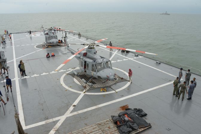 Indonesian navy officers coordinate the recovery of bodies taken to the vessel KRI Banda Aceh during recovery operations on Saturday, January 3.