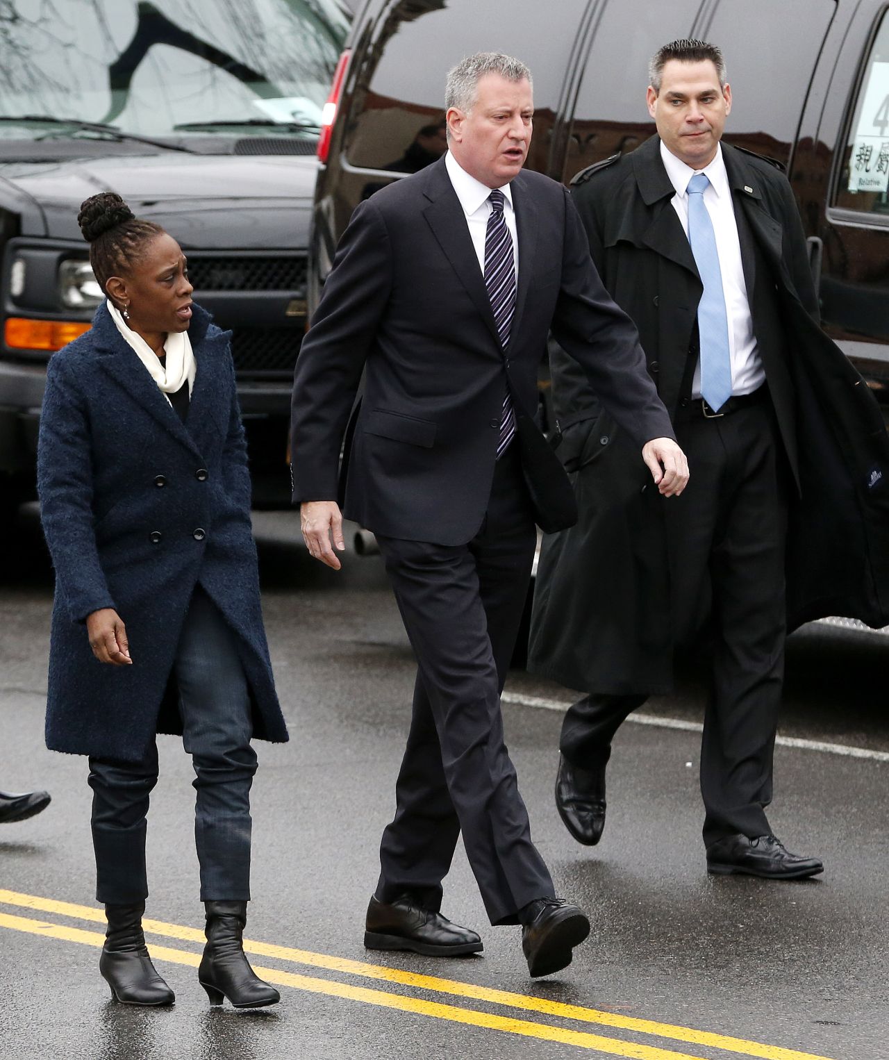 New York City Mayor Bill de Blasio, center, walks with his wife, Chirlane McCray, while arriving for the funeral.