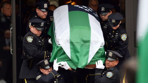 NYPD officers carry the casket of slain officer Wenjian Liu on January 4. 