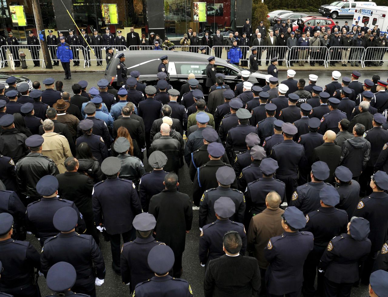 A hearse carrying the body of Officer Wenjian Liu passes by police officers in formation after his funeral in Brooklyn, New York, on Sunday, January 4.