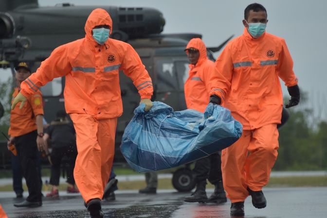 Members of an Indonesian search and rescue team carry items recovered from the search area in Pangkalan Bun on January 4.