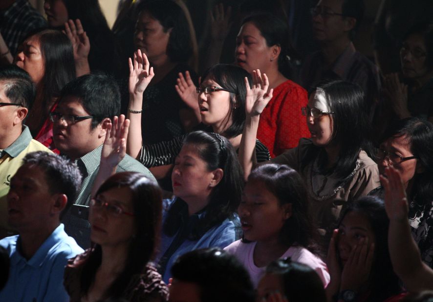 Members of the Mawar Sharon Church attend a prayer service for the relatives of lost loved ones January 4 in Surabaya, Indonesia.