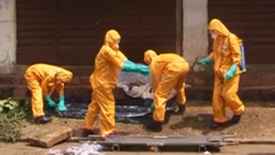 Health care workers getting sprayed down in Freetown, Sierra Leone on October 8, 2014
