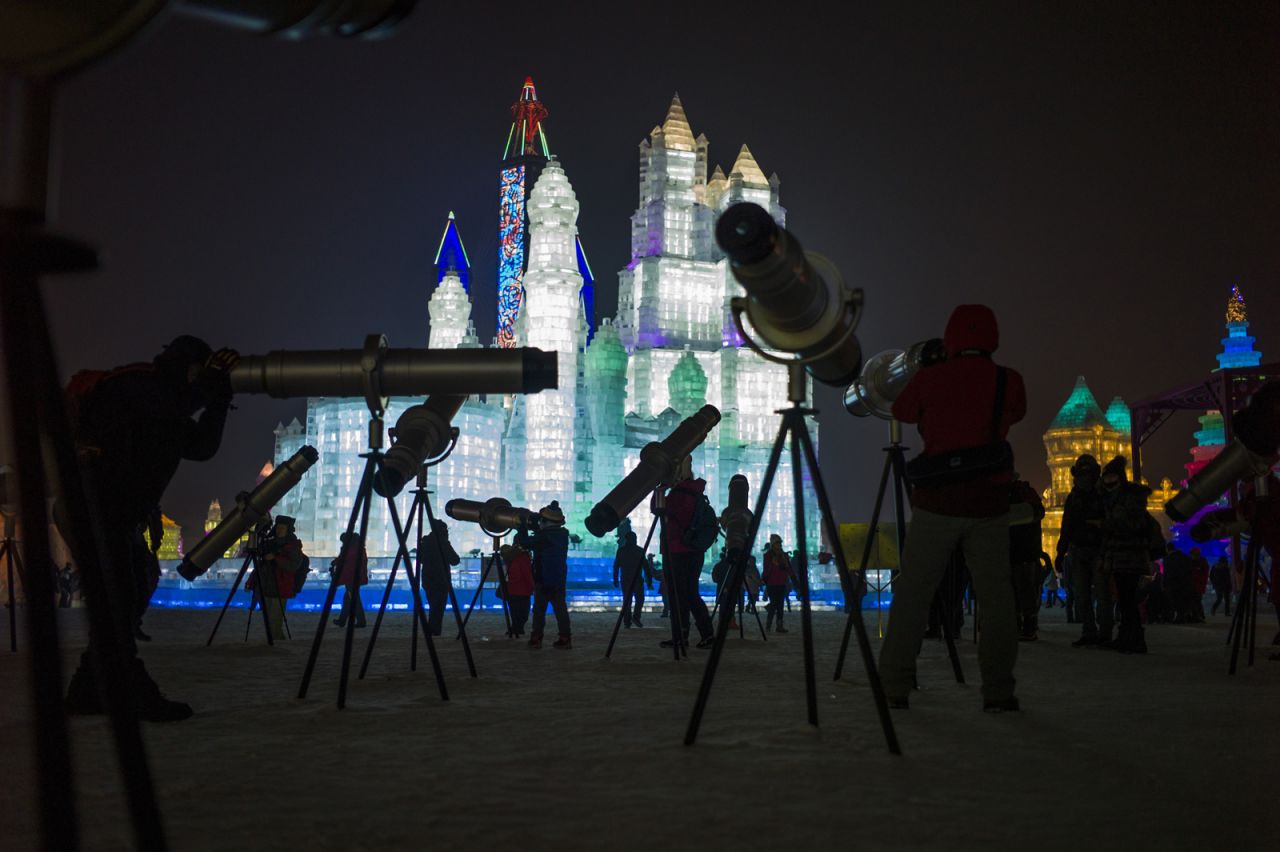 Visitors can use telescopes to get a better look at the ice sculptures.