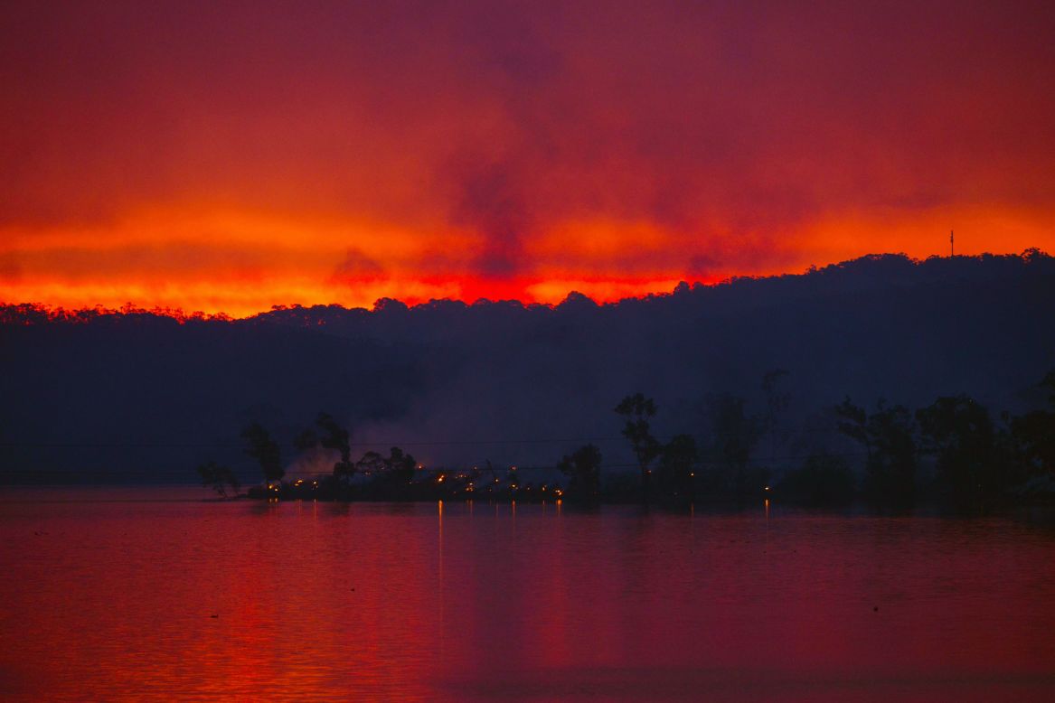 Embers glow against the smoke-filled sunset near the town of Gumeracha near Adelaide in South Australia. The fire started after midday on Friday, January 2, and is now in its fifth day.