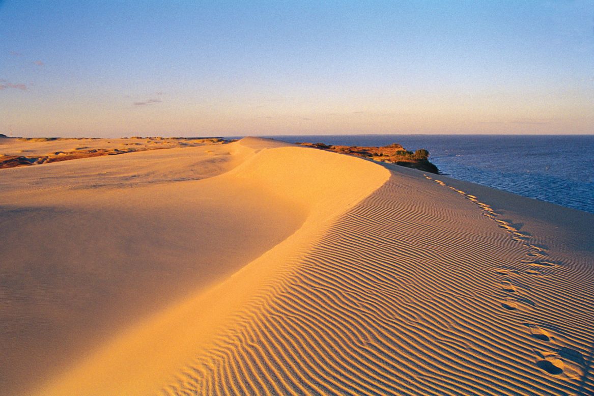 The Curonian Spit is a beautiful wall of sand dunes that traces a 98-kilometer arc from Klaipeda to Malinovka in Kaliningrad Oblast. 