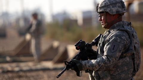 An American soldier stands guard at the Taji base complex which hosts Iraqi and US troops and is located thirty kilometres north of the capital Baghdad on December 29, 2014. T