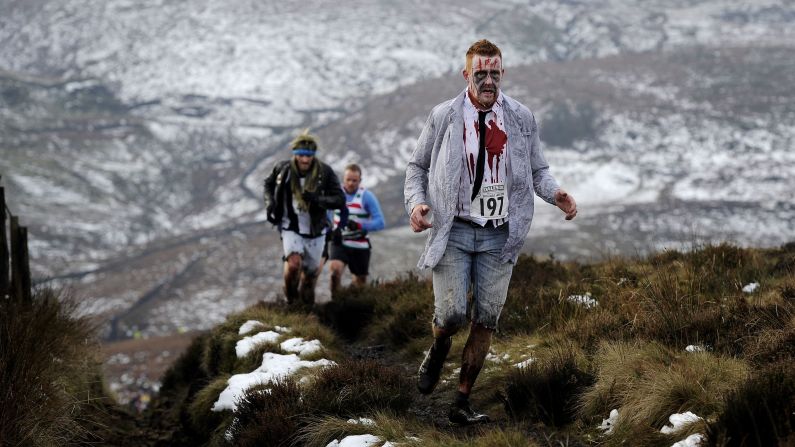 Costumed runners cross the Pennine hills near Naworth, England, during the traditional Auld Lang Syne race on Wednesday, December 31.