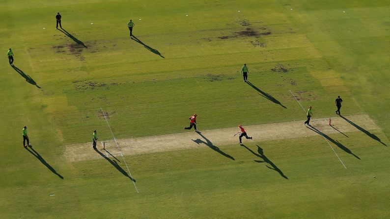 Michael Carberry and Adam Voges of the Perth Scorchers take a run during a Big Bash League cricket match Thursday, January 1, in Perth, Australia.