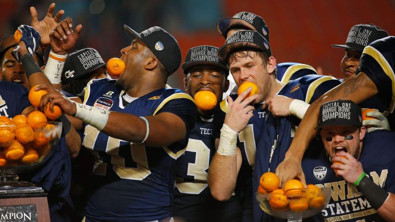 Georgia Tech football players pose with oranges after they defeated Mississippi State 49-34 to win the Orange Bowl, which was played Wednesday, December 31, in Miami Gardens, Florida.