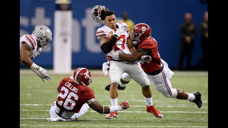 Ohio State running back Jalin Marshall loses his helmet as he is hit by Alabama linebacker Reggie Ragland during the Sugar Bowl on Thursday, January 1. Marshall's Buckeyes upset Alabama 42-35 in the second game of the College Football Playoff. They will play Oregon in the final.