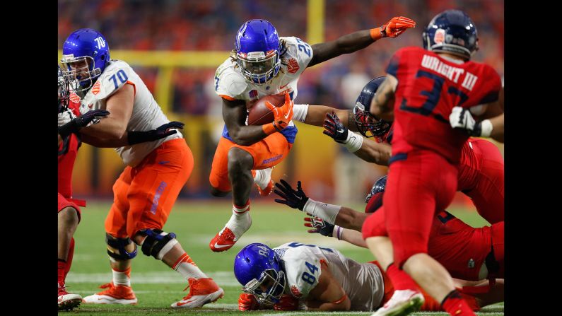 Boise State running back Jay Ajayi skips past Arizona defenders during the Fiesta Bowl, which took place Wednesday, December 31, in Glendale, Arizona. Ajayi had 134 yards and three touchdowns to help the Broncos win 38-30.