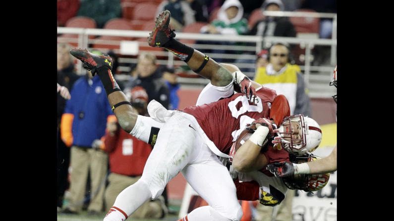 Stanford tight end Austin Hooper is wrapped up by a Maryland defender after making a catch Tuesday, December 30, at the Foster Farms Bowl in Santa Clara, California. Hooper had five receptions for 71 yards as Stanford rolled to a 45-21 victory.