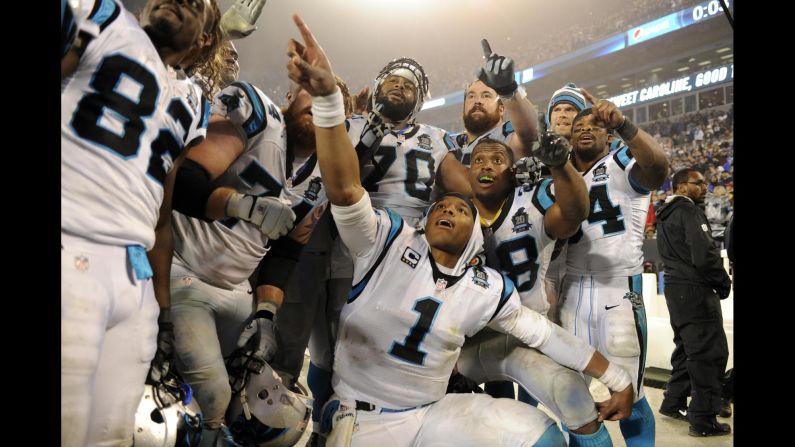 Some of the Carolina Panthers, including quarterback Cam Newton (No. 1), celebrate together after their playoff victory Saturday, January 3, in Charlotte, North Carolina. The Panthers beat the Arizona Cardinals 27-16 to advance to the next round.