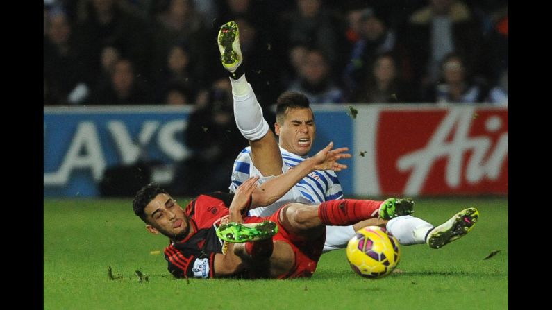 QPR defender Mauricio Isla, right, is tackled by Swansea City's Neil Taylor during a Premier League match played in London on Thursday, January 1.