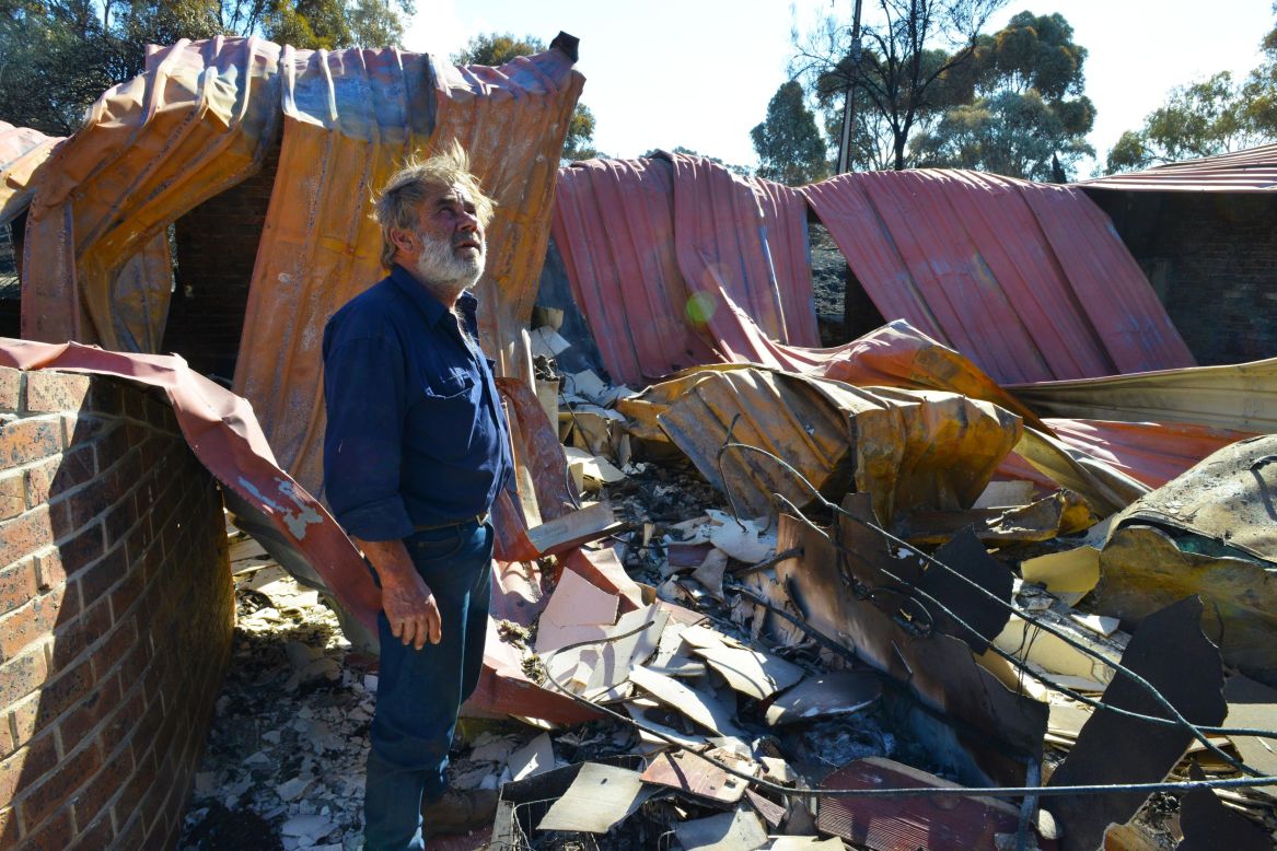 A resident surveys the remains of his home near the town of Kersbrook near Adelaide, South Australia. On Monday, the South Australian Premier said temporary accommodation has been provided for more than 30 families.