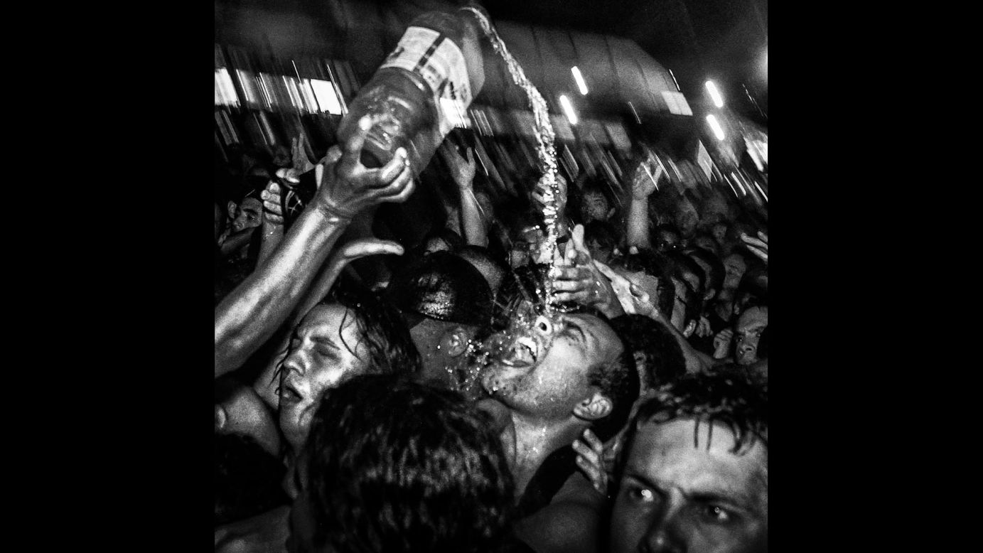 Liquid is poured on a concertgoer at a Pitty performance in 2013.