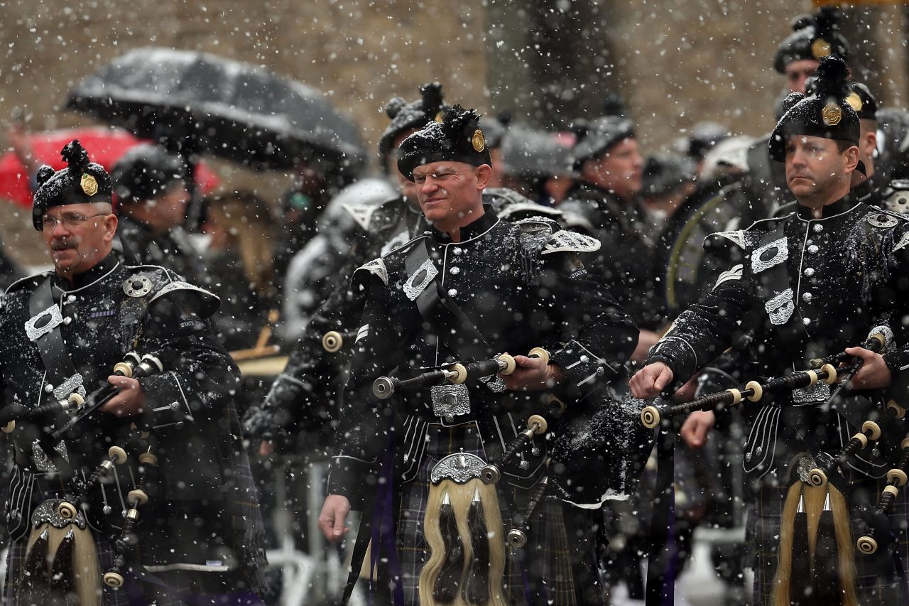 Bagpipers lead the procession into the church.