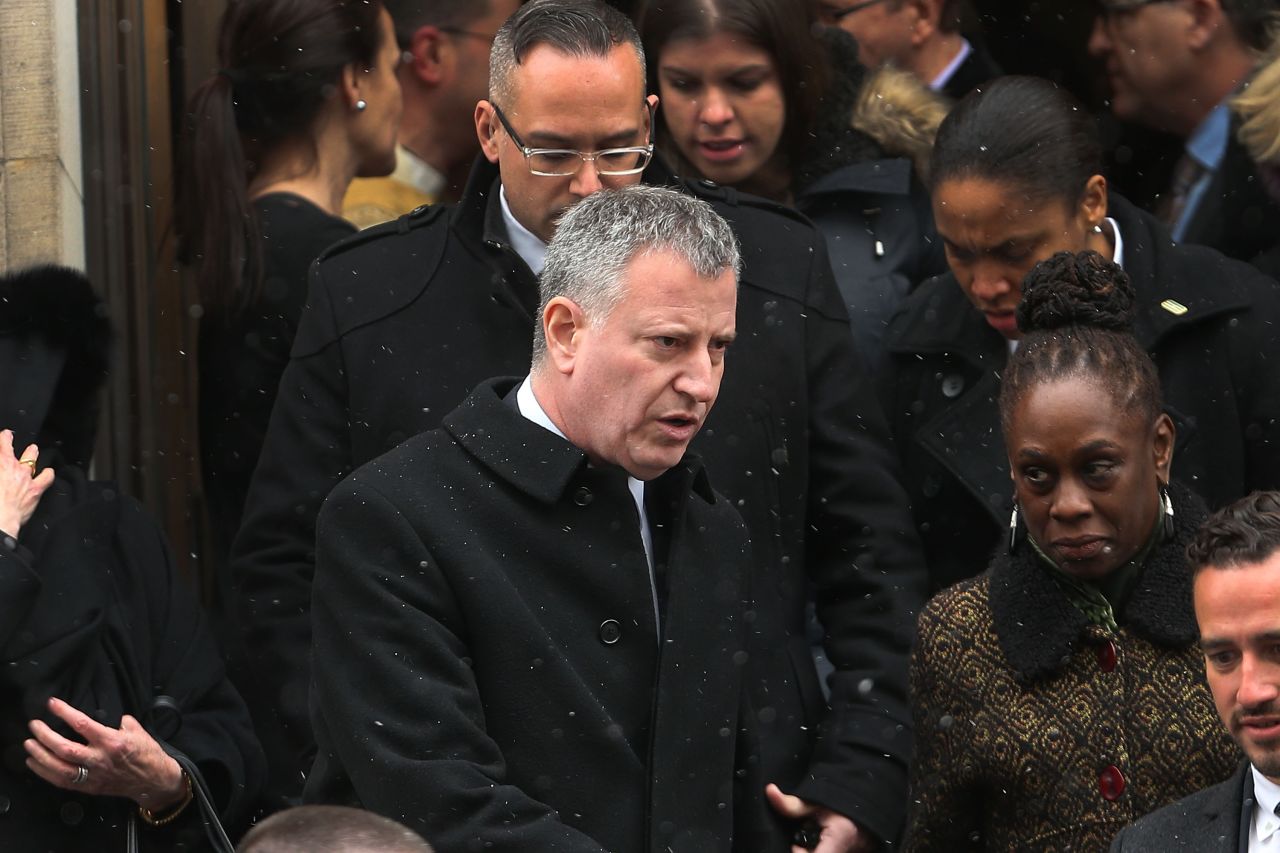 New York Mayor Bill de Blasio leaves the church with his wife, Chirlane McCray.