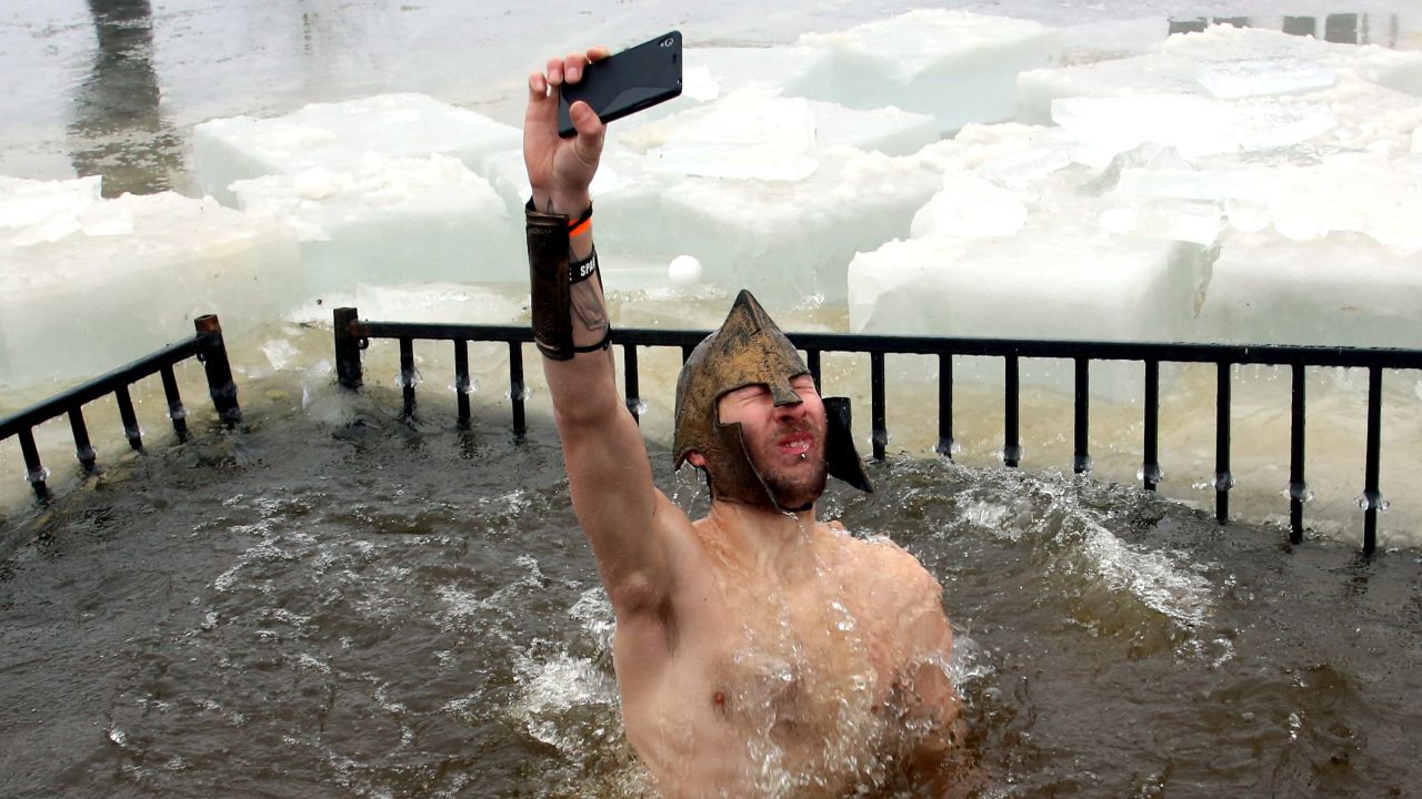 A man snaps a selfie as he takes part in the New Year's Day polar bear dip in Ottawa on Thursday, January 1. The event raised money to help fight pediatric cancer.