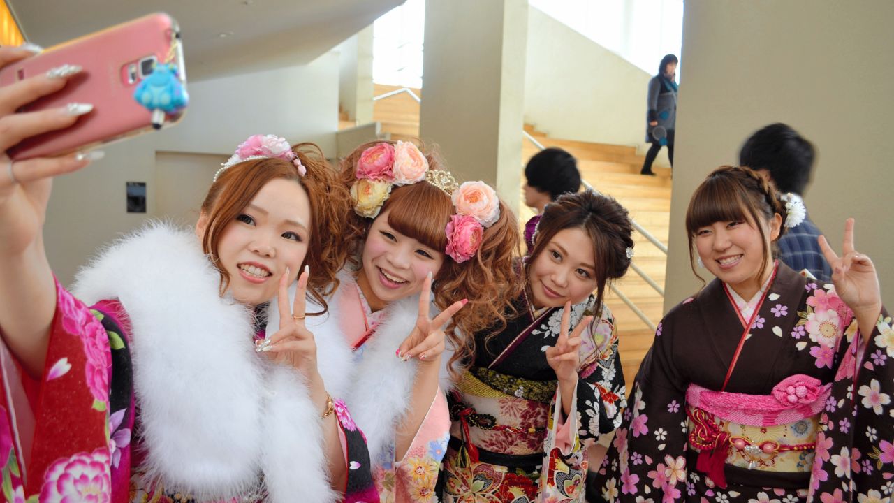 Young women in kimonos take a photo during a coming-of-age ceremony Saturday, January 3, in Otawara, Japan.