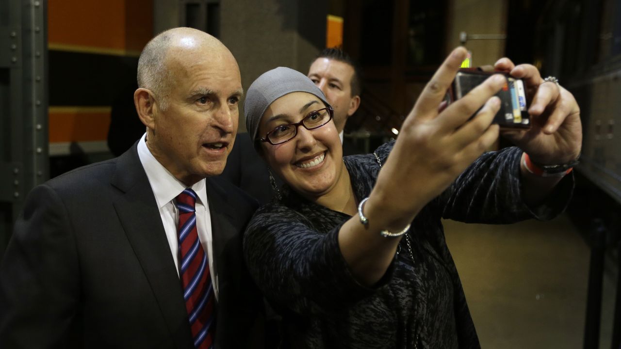 California Gov. Jerry Brown poses for a selfie at a reception held in his honor Monday, January 5, at the California State Railroad Museum in Sacramento, California. Earlier in the day, Brown was sworn in for his fourth term.