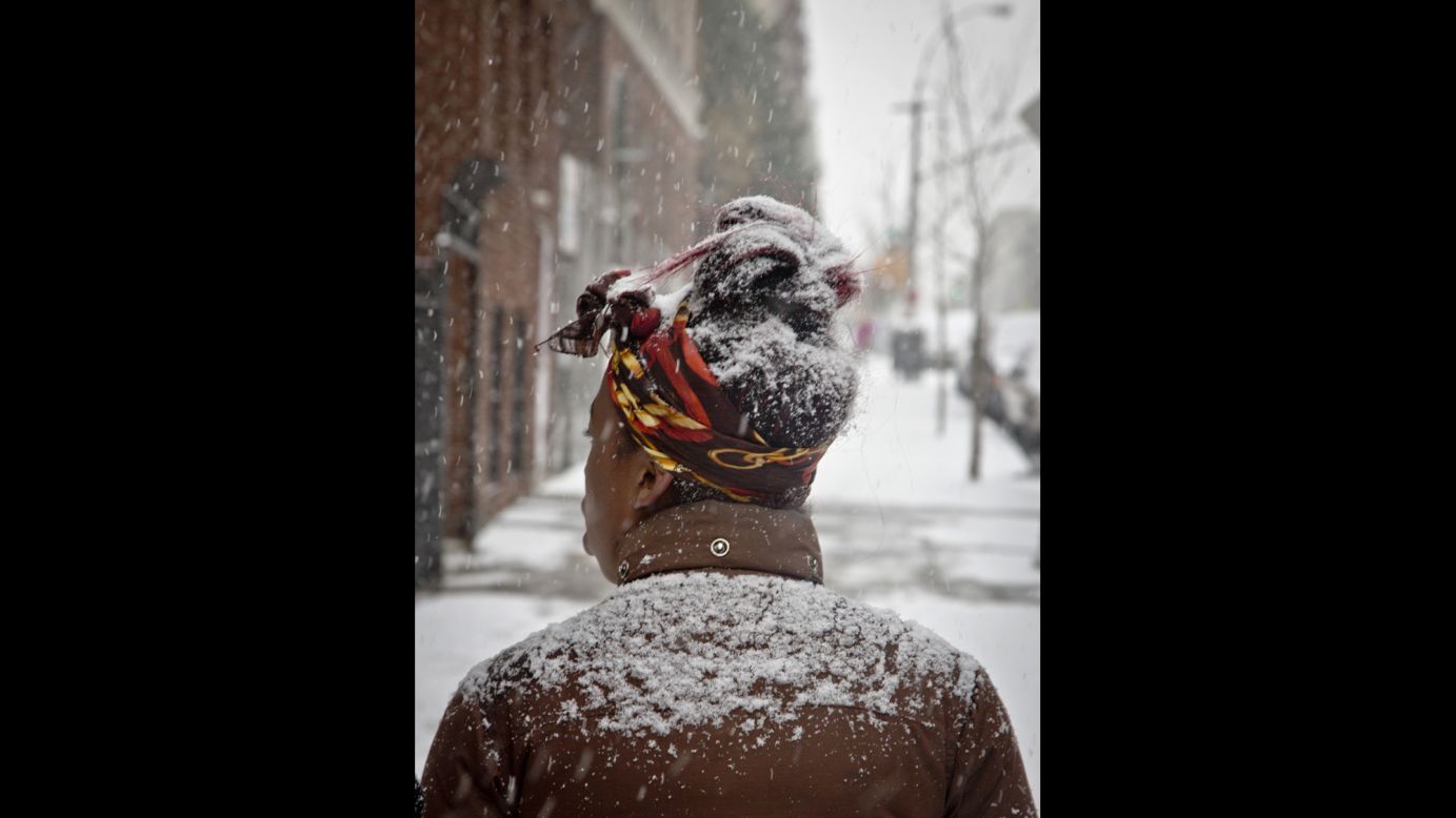 Snow partially covers a pedestrian on January 6 in the Bronx, New York.