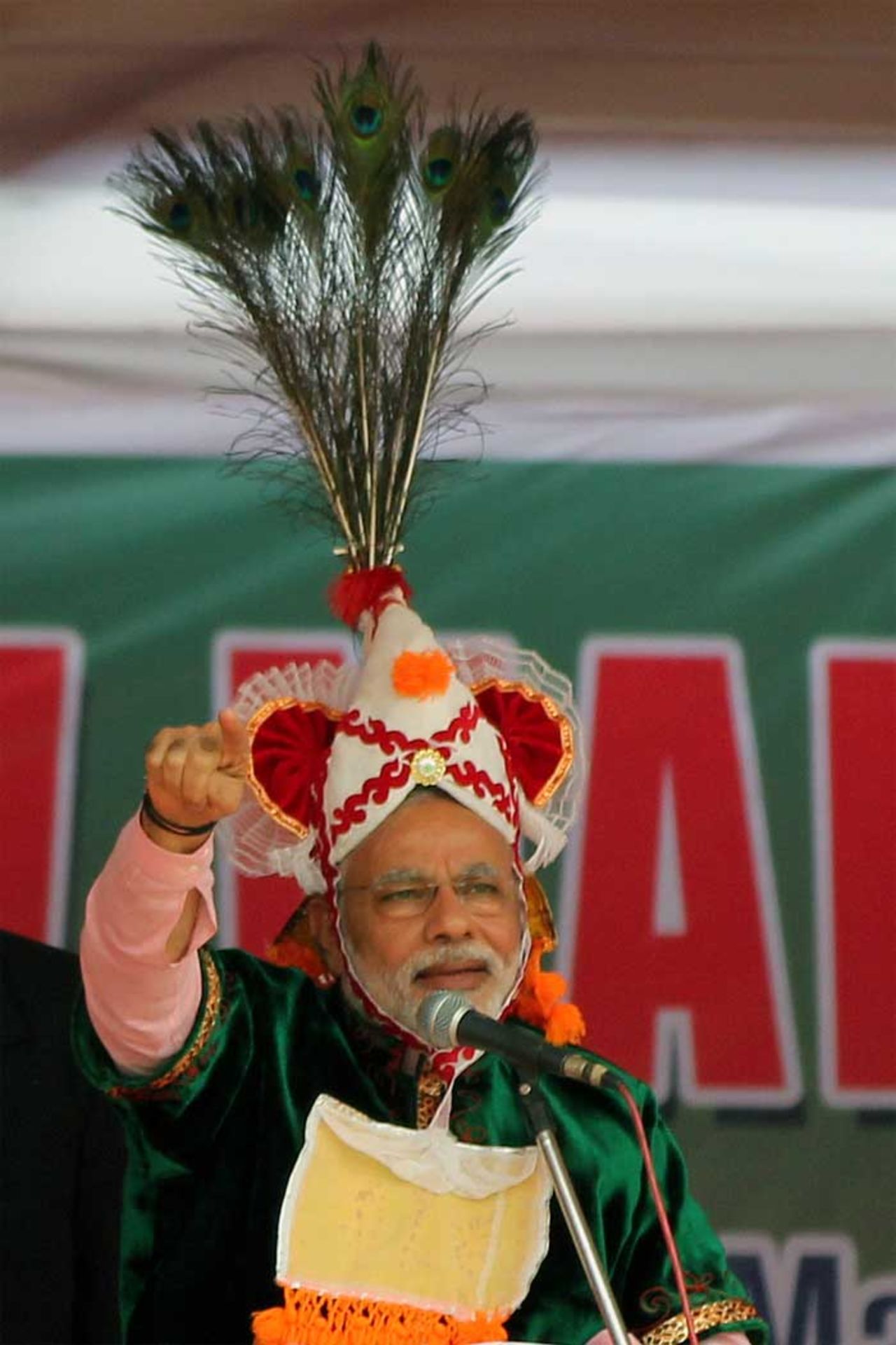 Seen here is another Manipuri headgear with peacock feathers usually worn by dancers who play the part of Lord Krishna, a Hindu God, in a traditional Manipuri dance. Modi wears it in Imphal, the state capital, during an election rally. 