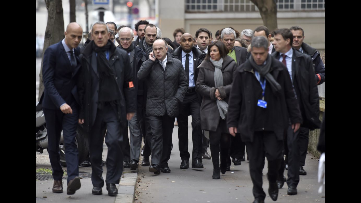 Paris Mayor Anne Hidalgo and Interior Minister Bernard Cazeneuve arrive at the scene.