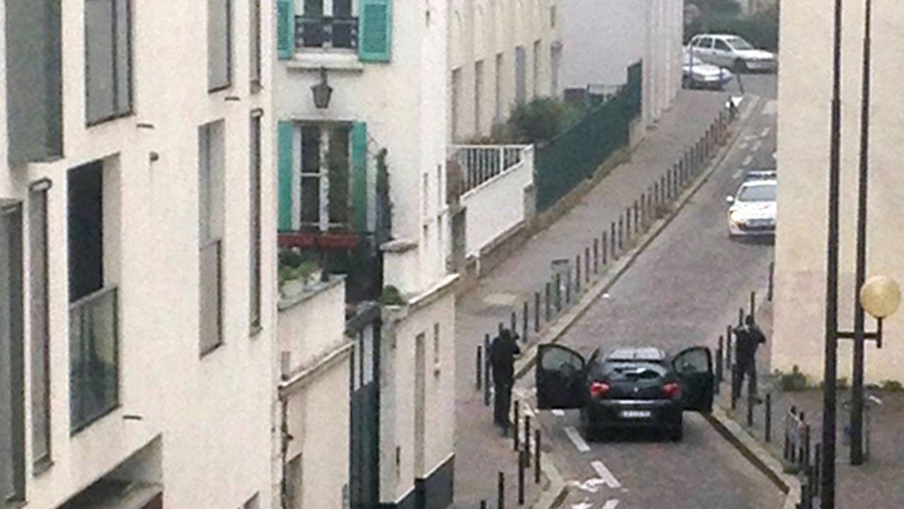 Gunmen face off with police officers in Paris on Wednesday, January 7. A terrorist attack at the Paris office of Charlie Hebdo, a French satirical magazine, left at least 12 people dead.