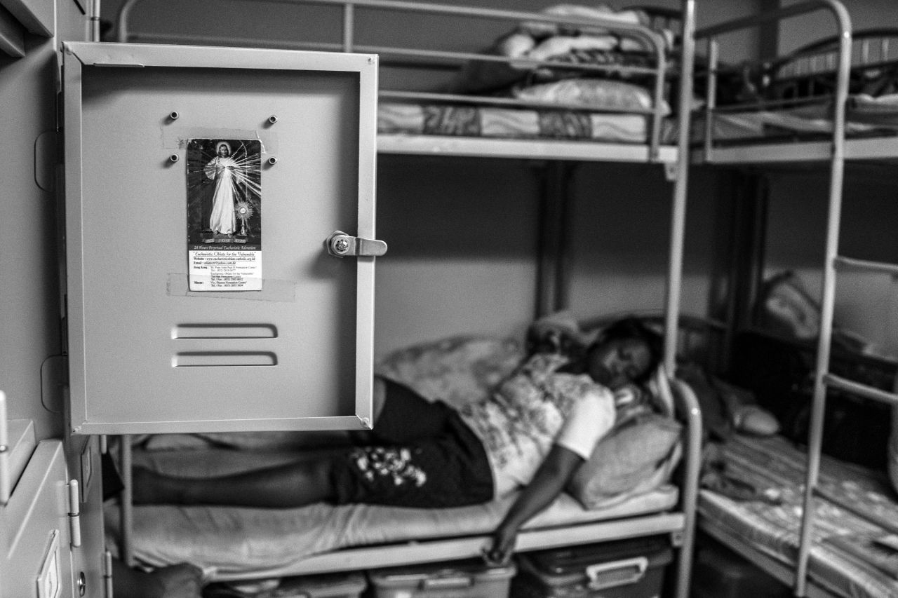 Thousands of migrant workers work silently and invisibly in Hong Kong homes. Kuryati, a migrant worker from Indonesia, was accused of stealing. She rests after a stressful court hearing. <br />