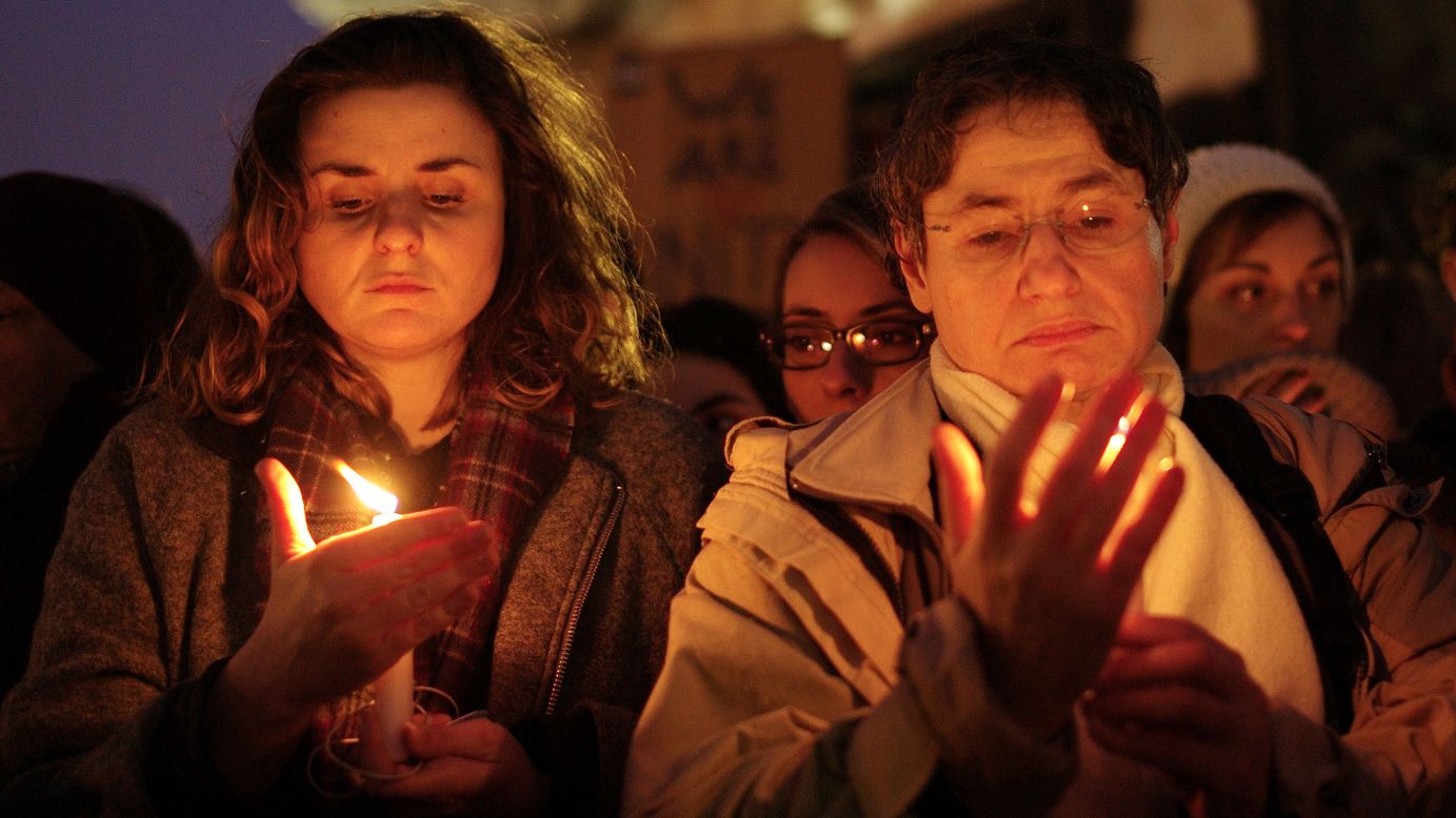 People in Paris hold candles on January 7. 