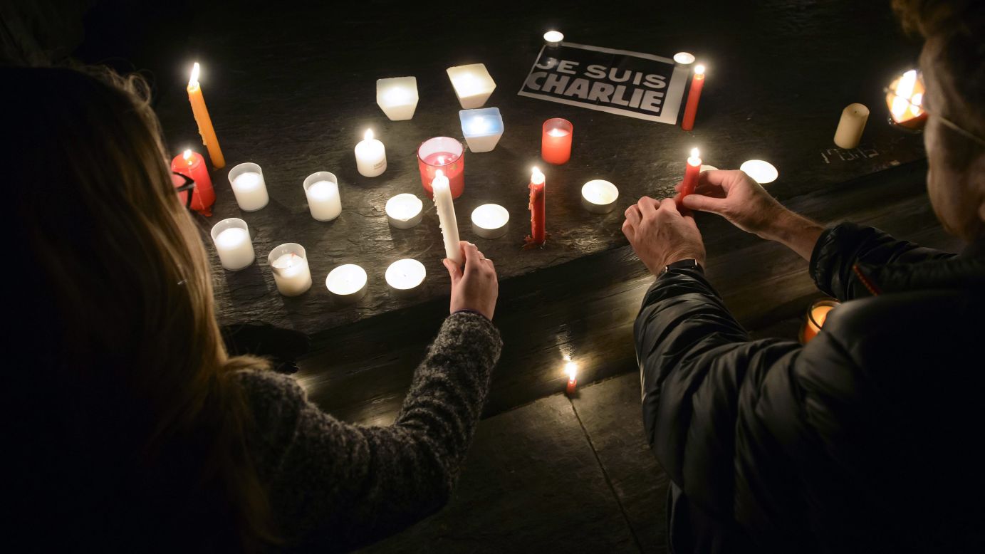 People light candles during a vigil in Geneva, Switzerland, on January 7.