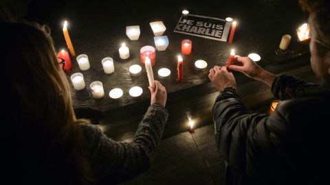 People light candles during a vigil in Geneva, Switzerland, on January 7.