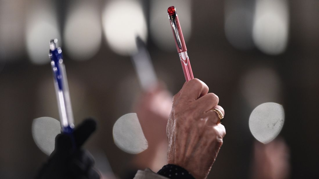 People hold up pens as a show of support in Rennes on January 7.