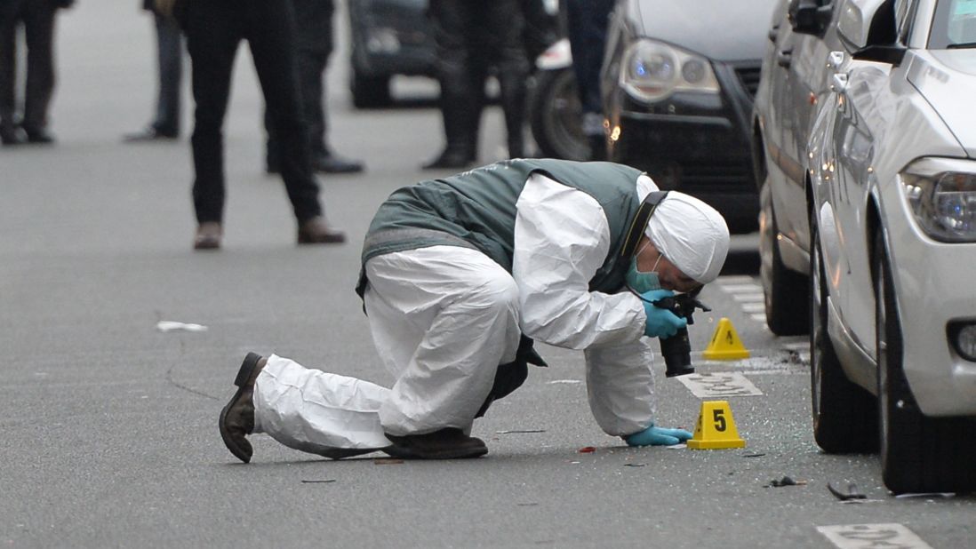 Police officers inspect evidence at the scene of the shooting.