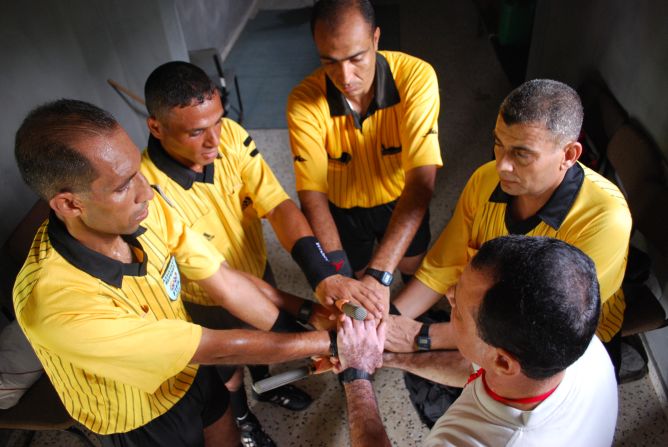 Referees In Gaza are pictured preparing for a match.