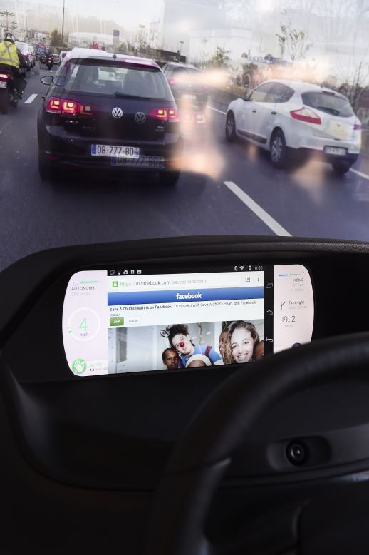 From CES, this mockup of a car dashboard shows Facebook on a wirelessly connected smartphone displayed on a Mobi/us autonomous dashboard -- a concept for interacting with a self-driving car as well as with a smartphone. When the car is driving on autopilot mode the driver can watch movies or surf the web on their wirelessly connected smartphone.
