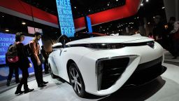 Attendees looks at the Toyota Mirai fuelcell automobile while it is displayed at the Toyota booth at the 2015 International CES at the Las Vegas Convention Center on January 6, 2015 in Las Vegas, Nevada. CES, the world's largest annual consumer technology trade show